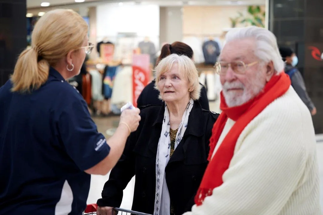 Photo of library staff member assisting people